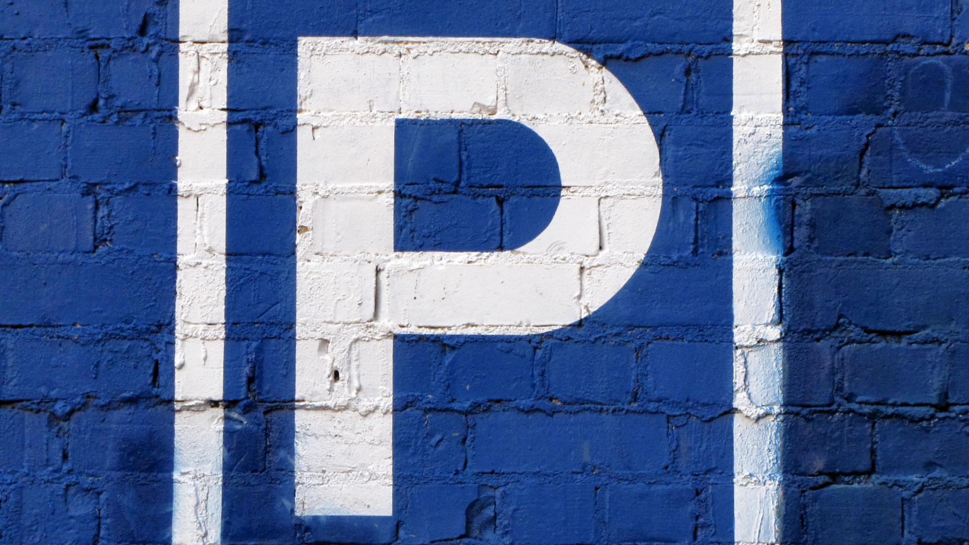 parkeer P op blauwe muur stockfoto.jpg